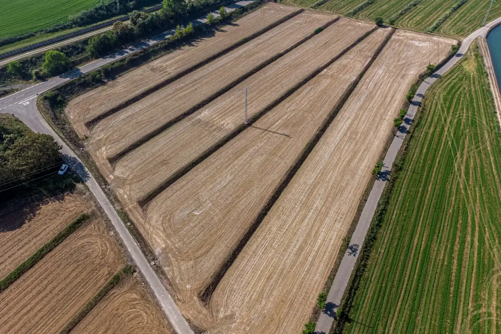 Aerial view of cultivated farmland crossed by a road